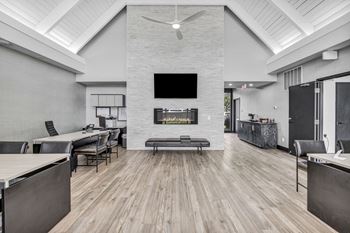 A modern living room with a fireplace and a television.